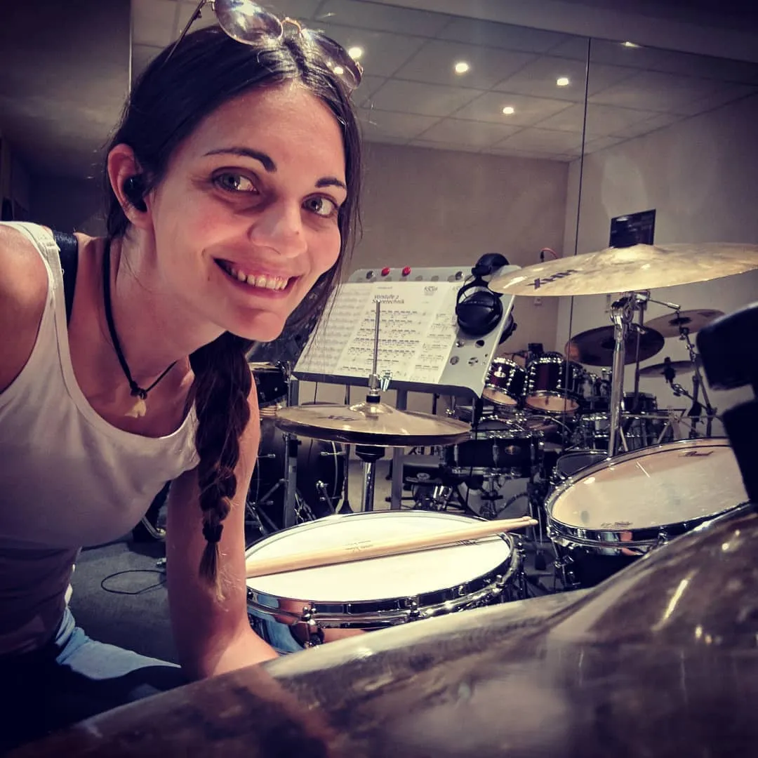 Verena Zaiser, the developer of Drumbitious, smiling behind her drum kit
